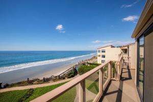 a balcony with a view of the beach at Escape at Seascape - SUR112 in Solana Beach
