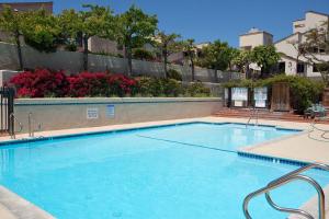 a large blue swimming pool in a building at Escape at Seascape - SUR112 in Solana Beach