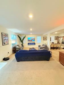 a large bedroom with a large bed and a living room at #stayRioVista -Country Club House with Hot Tub-Sauna-Firepit-Garden-Games in Rio Vista