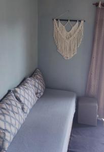 a bedroom with a bed and a chandelier at uma casa na viagem in Três Cachoeiras +9 photos