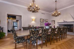 a dining room with a wooden table and chairs at Villa Paola 14 in Campiglia Marittima +32 photos