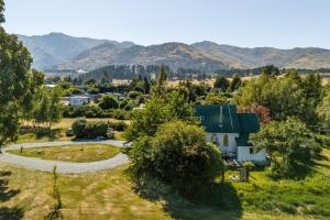 an aerial view of a village with mountains in the background at St Patrick's Church - Hawea Flat in Hawea Flat