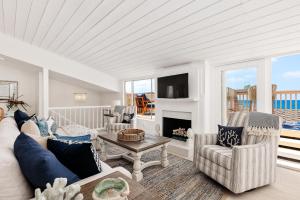 a living room with a couch and a fireplace at Solana Escape - SUR44 in Solana Beach