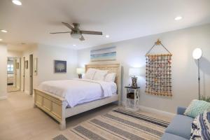a bedroom with a bed and a ceiling fan at Solana Escape - SUR44 in Solana Beach +42 photos