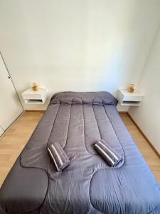 a large bed in a room with two tables at Amoblado Temporal M&S 4 M in Neuquén +30 photos
