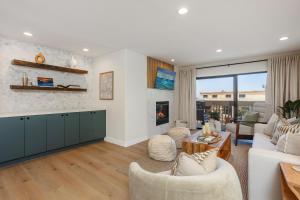 a living room with a couch and a fireplace at Ocean Whisper - SBTC238 in Solana Beach