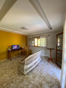 a living room with a crib in the middle of the room at Casa Sabino in Tamandaré