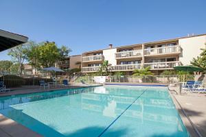 a swimming pool in front of a apartment building at Ocean Whisper - SBTC238 in Solana Beach