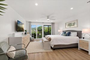 a white bedroom with a bed and a window at Fairway Haven - CB2507 in Carlsbad +22 photos