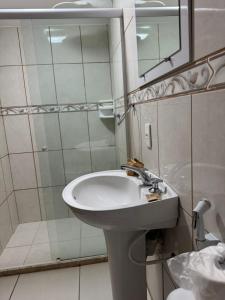 a bathroom with a sink and a mirror and a shower at Pousada Crystal Palace in Petrópolis +35 photos
