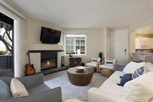 a living room with a couch and a fireplace at Trackside Tides - DM2925 in San Diego