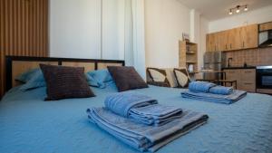 a blue bed with towels on top of it at ILIRIA Apartment in Durrës