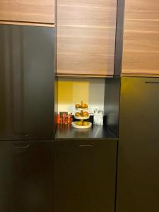 a kitchen with black cabinets and a plate of food at Cosy et Arty in Paris
