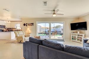 a living room with a couch and a tv at 4 Mi to Historic Dtwn Venice Home with Heated Pool! in Venice