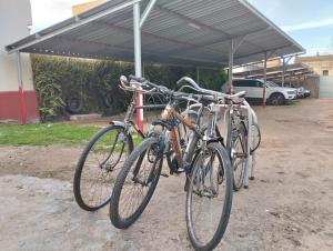 a group of bikes parked under a canopy at HOTEL CENTRAL - Estacionamiento in Treinta y Tres