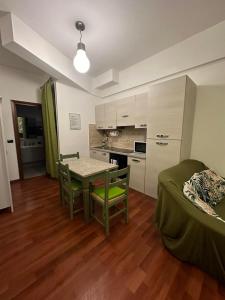 a living room with a table and chairs and a kitchen at Cute apartment next to vatican in Rome