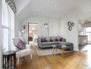 a living room with a couch and a table at Harlech Apartments - Efnisien in Harlech