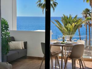 a dining room with a table and a view of the ocean at Callao Ocean View Luxury, air condition, wifi in Callao Salvaje