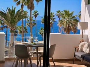 a dining room with a table with a view of the ocean at Callao Ocean View Luxury, air condition, wifi in Callao Salvaje +68 photos