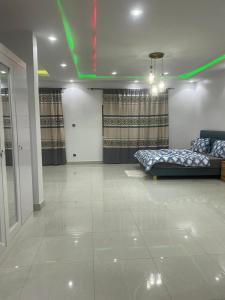 sala de estar con 2 camas y luz verde en Villa Cissé, en Saly Portudal