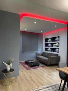 a living room with a couch and a table at Gold Apartment Tirana in Tirana