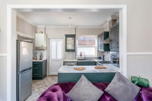 a kitchen with green cabinets and a purple couch at Hampton House in Stockton-on-Tees +43 photos