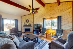 a living room with a couch and chairs and a tv at Pines 4058 in Pagosa Springs