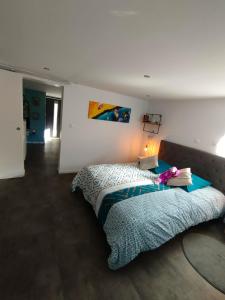 a bedroom with a bed with a lamp on it at Le Ptit Lou in Kaysersberg