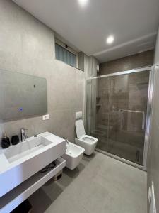a bathroom with a sink and a toilet and a shower at The Best Shkoder in Shkodër