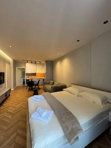 a bedroom with a large bed and a living room at The Best Shkoder in Shkodër