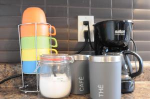 a kitchen counter with a mixer and a container of milk at Logis des prodiges - Le 775 in Rouyn-Noranda