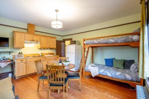 a kitchen and dining room with a bunk bed at Victoria Falls House Inn in Nelson