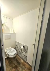 a bathroom with a toilet and a toilet paper dispenser at Charmant studio 30m2 in Clermont-Ferrand