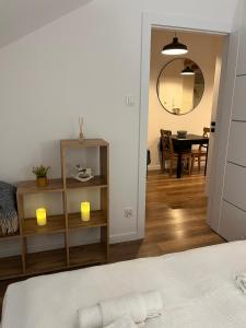 a bedroom with a bed and a dining room at Apartament Tatarska 4 in Przemyśl +6 photos