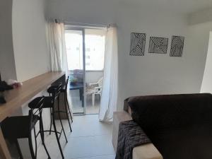 a living room with a couch and a table and chairs at Apartamento, 5 minutos da praia in Porto Belo