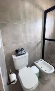 a bathroom with a white toilet and a sink at Cerros de Cafayate, Casa Nº1 in Cafayate