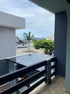 a kitchen with a ping pong table on a balcony at Pousada Vila do Meio in Pinheiro