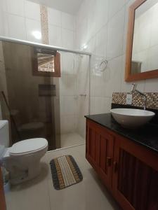 a bathroom with a toilet and a sink and a shower at Sítio da Pedra in Cunha