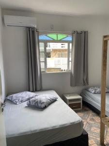 Ένα ή περισσότερα κρεβάτια σε δωμάτιο στο Pousada Vila do Meio