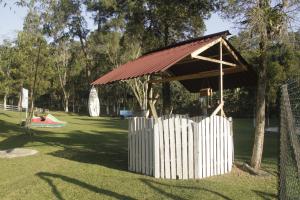 a park with a pavilion and a child in a swing at Eco Cabana 01 in Santo André