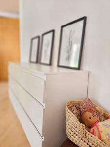 a white dresser with a doll in a basket at Perle am Vierwaldstättersee in Fluelen