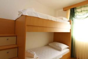 Dos literas en una habitación con ventana. en Apartment in Klimno - Insel Krk 51052, en Klimno