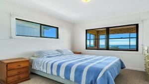 Ένα ή περισσότερα κρεβάτια σε δωμάτιο στο Minnie Water Beach House