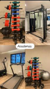 a gym with a rack with dumbbells and a mirror at Avalon Residence in João Pessoa +10 photos