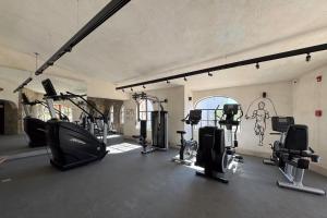 a gym with several treadmills and exercise bikes at Casa Nima by Lumina in San José del Cabo