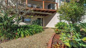 a garden in front of a house with plants at Wooli Waves in Wooli