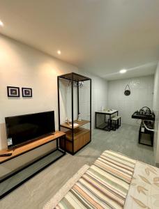 a living room with a large flat screen tv at Flats Raízes da Barra in Maragogi
