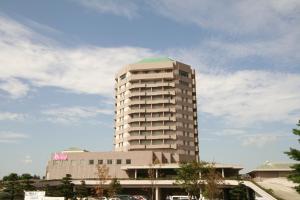 a tall building with a green dome on top of it at Sendai Hills Hotel in Sendai