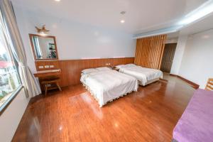 Ένα ή περισσότερα κρεβάτια σε δωμάτιο στο Long Yun Leisure Farm