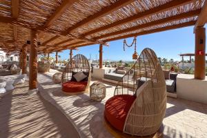 a patio with two hammocks under a wooden pergola at Casa Nima by Lumina in San José del Cabo
